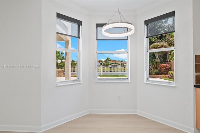 16477 SW 67th Ter, Miami, FL 33193 - spare room with healthy amount of natural light, light wood finished floors, crown molding, and baseboards
