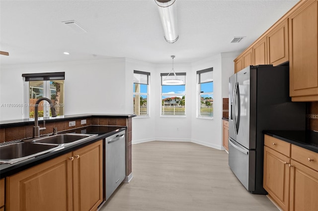 16477 SW 67th Ter, Miami, FL 33193 - kitchen with stainless steel appliances, a sink, dark countertops, light wood-type flooring, and healthy amount of natural light