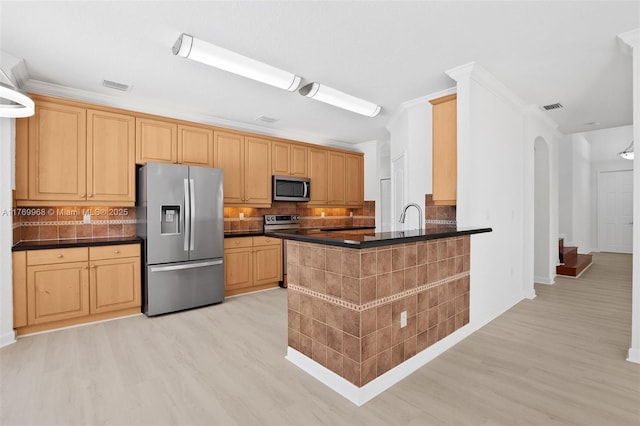 16477 SW 67th Ter, Miami, FL 33193 - kitchen with appliances with stainless steel finishes, light wood-style flooring, dark countertops, and backsplash