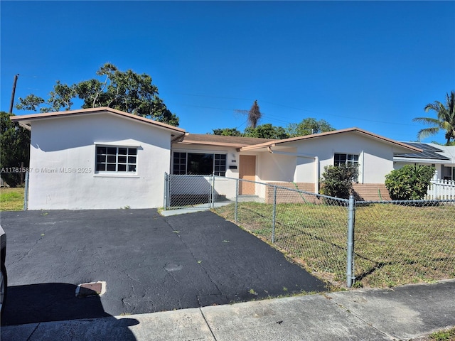 single story home featuring a fenced front yard, a front lawn, and stucco siding