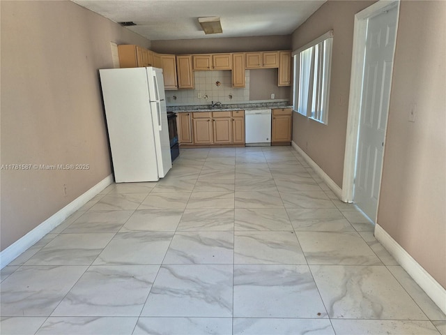 kitchen with baseboards, light brown cabinets, a sink, white appliances, and marble finish floor