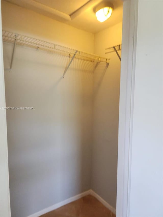 6061 Shakerwood Cir Unit 208, Tamarac, FL 33319 - walk in closet featuring tile patterned flooring