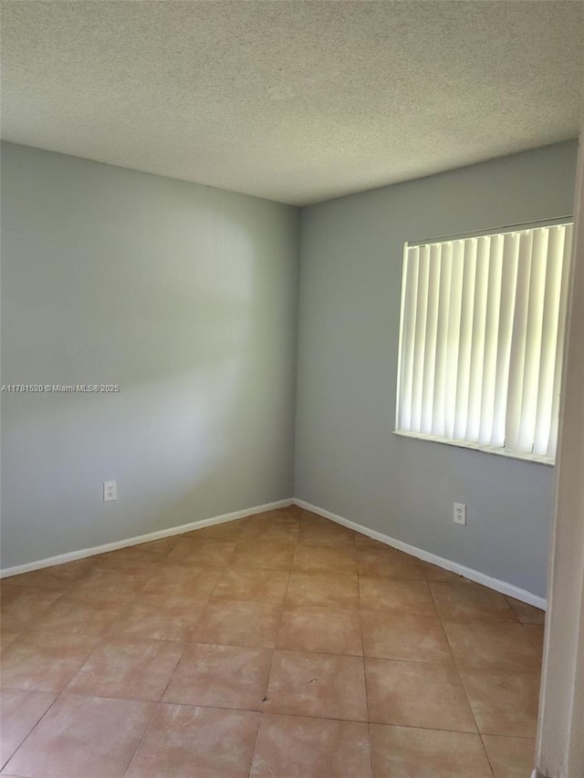 6061 Shakerwood Cir Unit 208, Tamarac, FL 33319 - spare room featuring a textured ceiling and baseboards