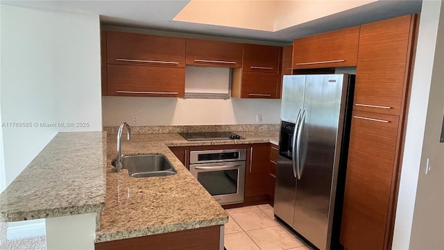 2681 N Flamingo Rd Unit 302S, Sunrise, FL 33323 - kitchen with a peninsula, light tile patterned floors, brown cabinets, appliances with stainless steel finishes, and a sink