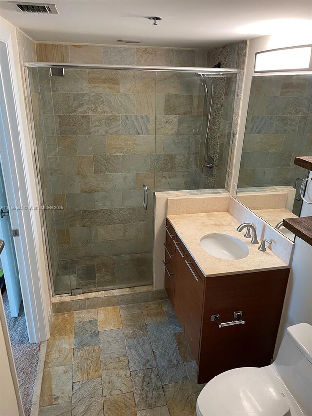 2681 N Flamingo Rd Unit 302S, Sunrise, FL 33323 - full bathroom featuring stone finish floor, vanity, visible vents, toilet, and a stall shower