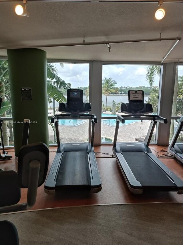 2681 N Flamingo Rd Unit 302S, Sunrise, FL 33323 - workout area featuring expansive windows, a water view, and track lighting