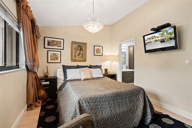 3062 S Oakland Forest Dr Unit 205, Oakland Park, FL 33309 - bedroom featuring light wood-style flooring, a notable chandelier, and baseboards