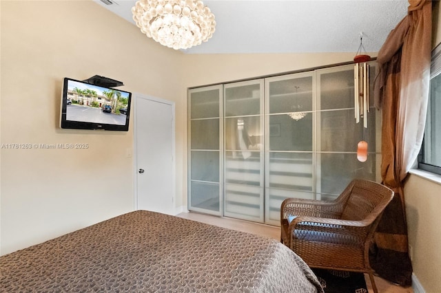 3062 S Oakland Forest Dr Unit 205, Oakland Park, FL 33309 - bedroom with access to exterior, an inviting chandelier, and lofted ceiling
