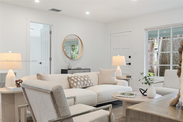 living area with visible vents and recessed lighting