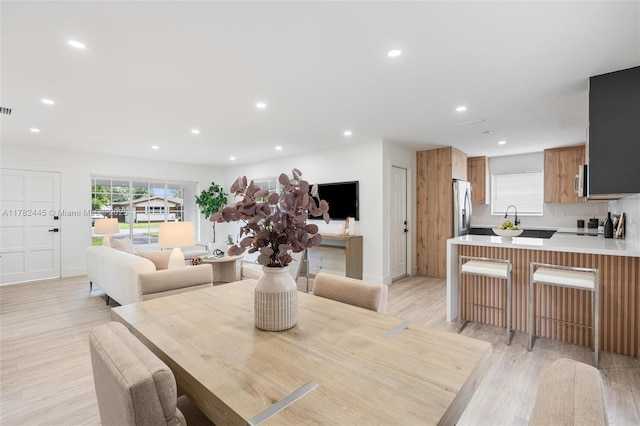 dining room with light wood-style flooring, visible vents, and recessed lighting