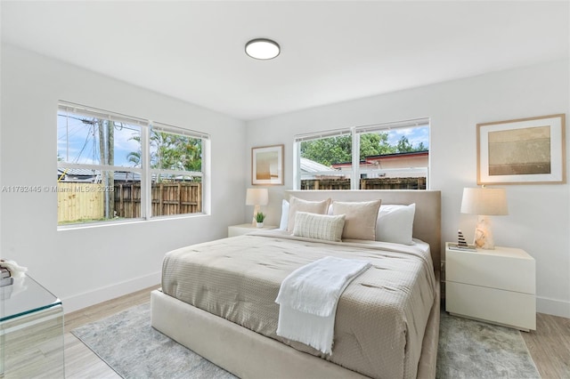 bedroom featuring baseboards and wood finished floors