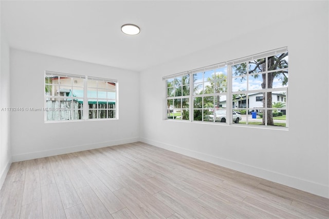 empty room featuring wood finished floors and baseboards