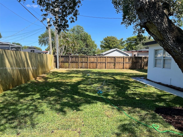 view of yard with a fenced backyard