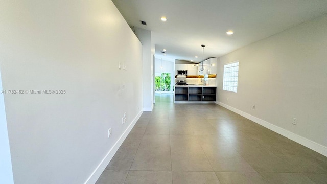 interior space featuring light tile patterned floors, baseboards, visible vents, and recessed lighting