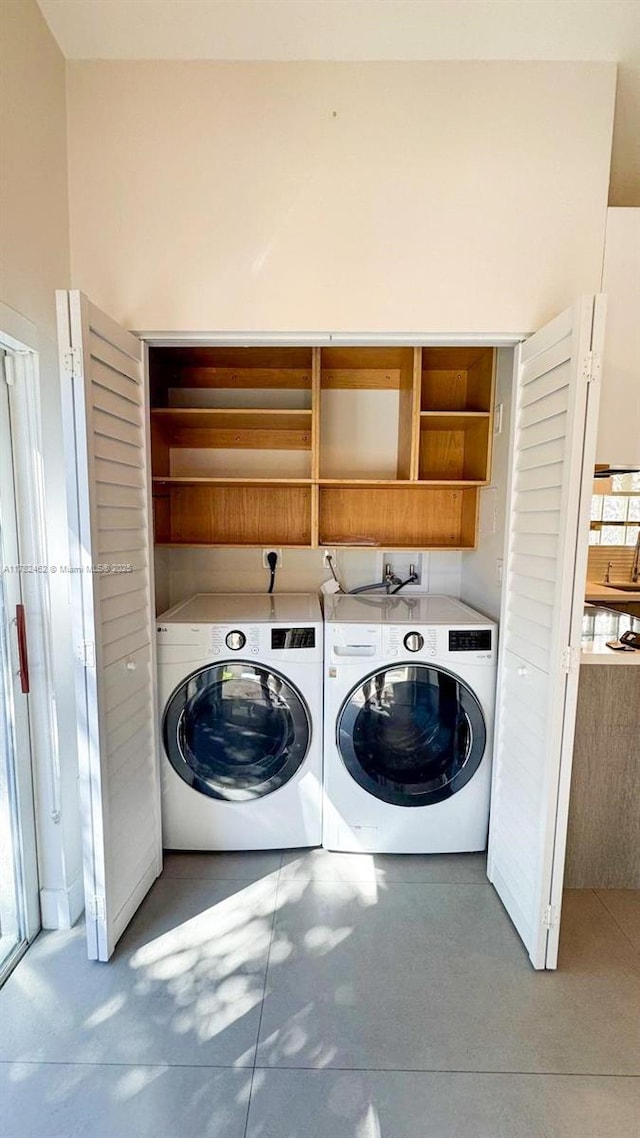 laundry room featuring washing machine and dryer and laundry area