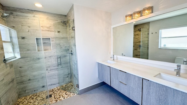 bathroom featuring a stall shower, a sink, and tile patterned floors