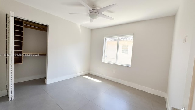 unfurnished bedroom featuring a closet, baseboards, ceiling fan, and tile patterned flooring