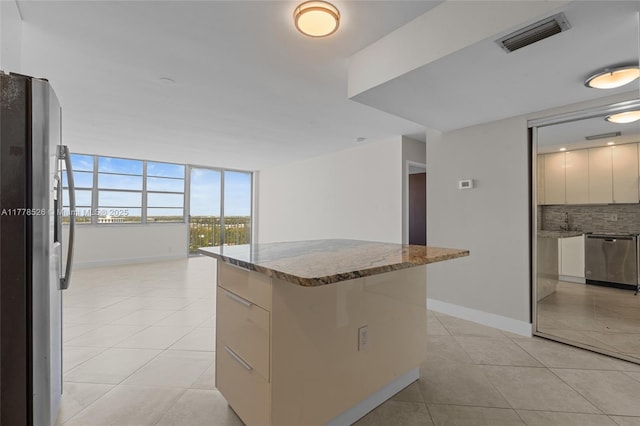 2100 Sans Souci Blvd Unit A1509, North Miami, FL 33181 - kitchen featuring a kitchen island, visible vents, stainless steel appliances, and light tile patterned floors
