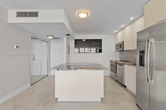 2100 Sans Souci Blvd Unit A1509, North Miami, FL 33181 - kitchen featuring decorative backsplash, stainless steel appliances, visible vents, and stone counters