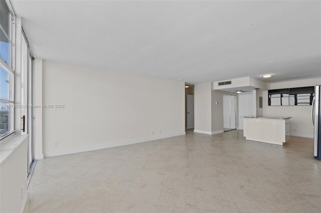 2100 Sans Souci Blvd Unit A1509, North Miami, FL 33181 - unfurnished living room featuring visible vents and baseboards
