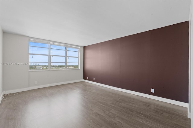 2100 Sans Souci Blvd Unit A1509, North Miami, FL 33181 - unfurnished room featuring baseboards and wood finished floors