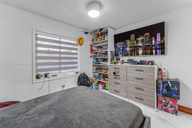 bedroom featuring marble finish floor