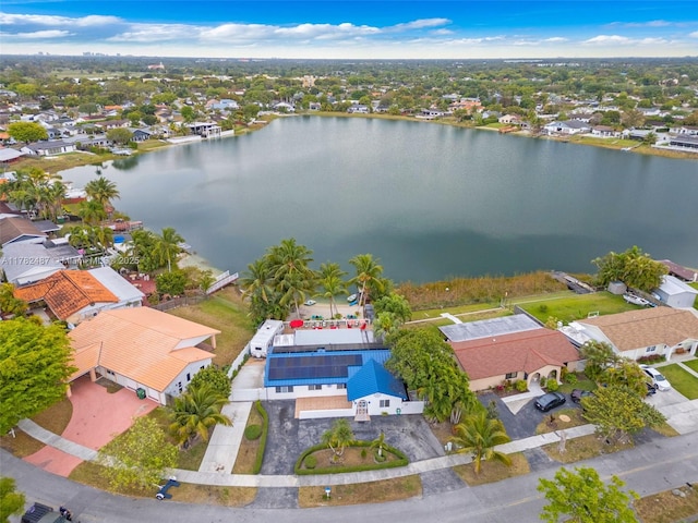 drone / aerial view with a water view and a residential view