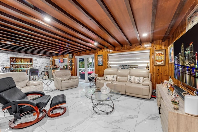 living room featuring wooden walls and marble finish floor