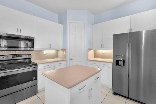 kitchen with a kitchen island, appliances with stainless steel finishes, tasteful backsplash, light tile patterned floors, and light countertops