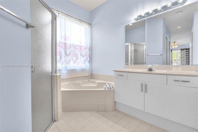 bathroom with ceiling fan, vanity, tile patterned floors, a garden tub, and a stall shower