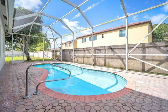 view of swimming pool featuring a patio, a fenced in pool, a lanai, and a fenced backyard
