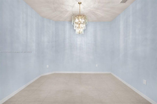 empty room featuring an inviting chandelier, baseboards, and visible vents