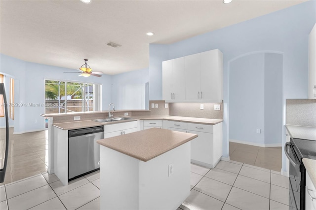 kitchen with a sink, arched walkways, a peninsula, stainless steel dishwasher, and visible vents
