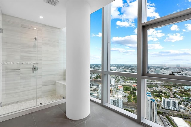 851 NE 1st Ave Ph 5500, Miami, FL 33132 - bathroom with a shower stall, expansive windows, visible vents, a city view, and tile patterned floors