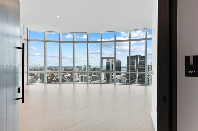 851 NE 1st Ave Ph 5500, Miami, FL 33132 - empty room featuring a view of city and a wall of windows