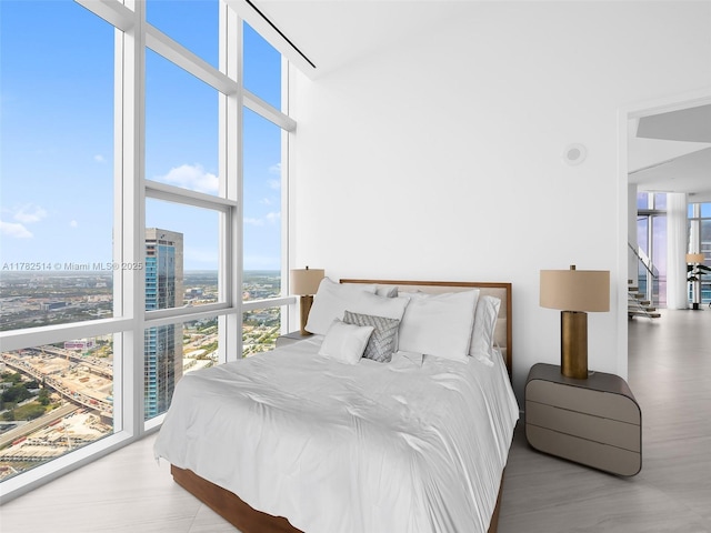 851 NE 1st Ave Ph 5500, Miami, FL 33132 - bedroom featuring a view of city, wood finished floors, expansive windows, and multiple windows