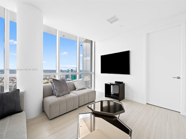 851 NE 1st Ave Ph 5500, Miami, FL 33132 - living room with a wall of windows, wood finished floors, and visible vents
