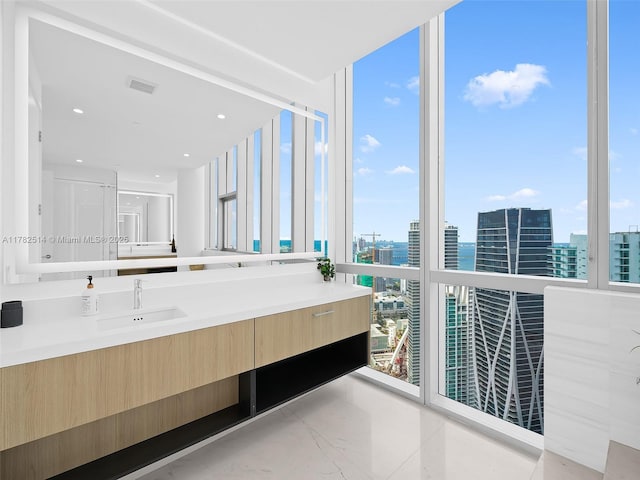 851 NE 1st Ave Ph 5500, Miami, FL 33132 - bathroom with vanity, expansive windows, marble finish floor, visible vents, and a view of city