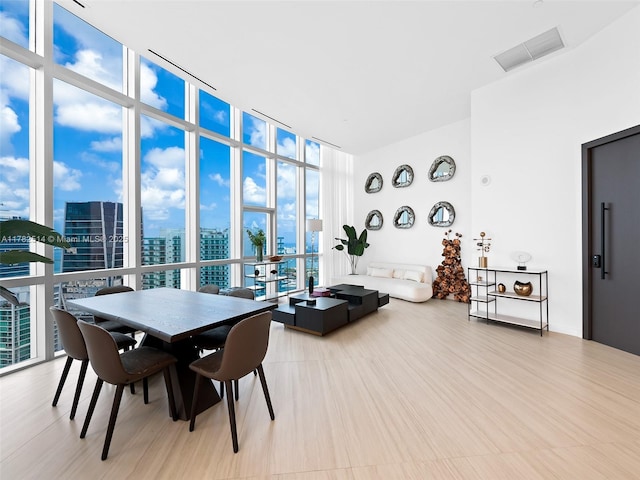 851 NE 1st Ave Ph 5500, Miami, FL 33132 - dining space with a view of city, visible vents, plenty of natural light, and expansive windows