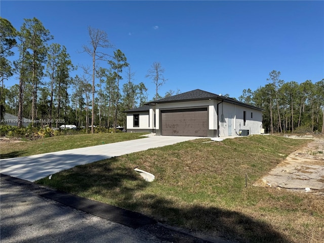 1316 Broadway Ave, Lehigh Acres, FL 33972 - view of side of home with an attached garage, stucco siding, a yard, driveway, and central AC