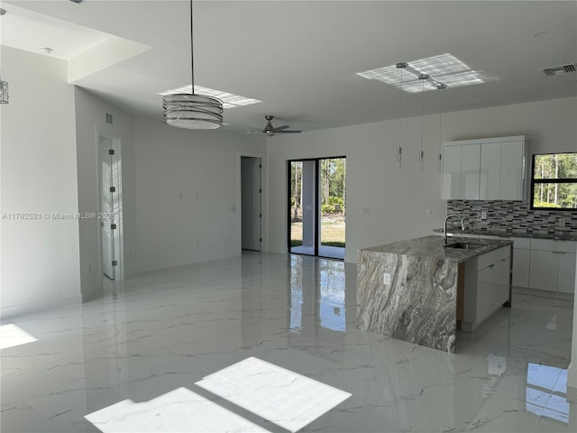 1316 Broadway Ave, Lehigh Acres, FL 33972 - kitchen featuring modern cabinets, a sink, white cabinets, tasteful backsplash, and open floor plan