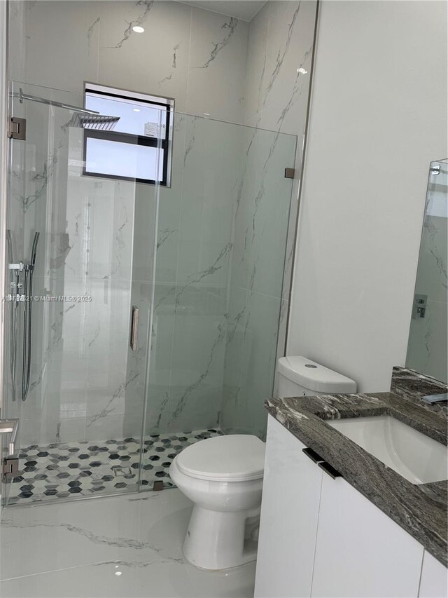 1316 Broadway Ave, Lehigh Acres, FL 33972 - bathroom featuring toilet, vanity, a marble finish shower, and marble finish flooring