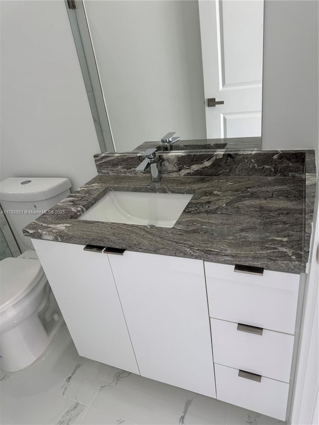 1316 Broadway Ave, Lehigh Acres, FL 33972 - half bathroom with marble finish floors, vanity, and toilet