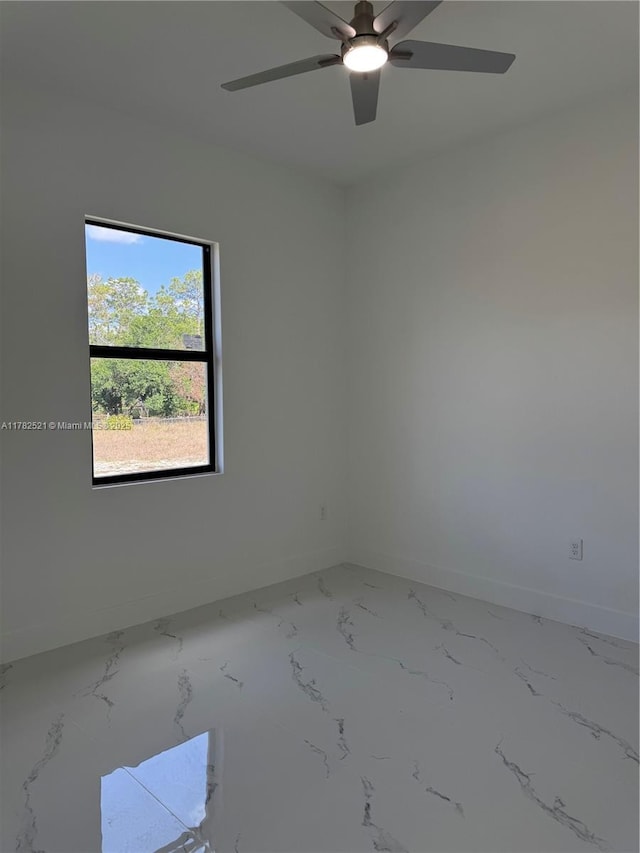 1316 Broadway Ave, Lehigh Acres, FL 33972 - spare room with baseboards, ceiling fan, and marble finish flooring
