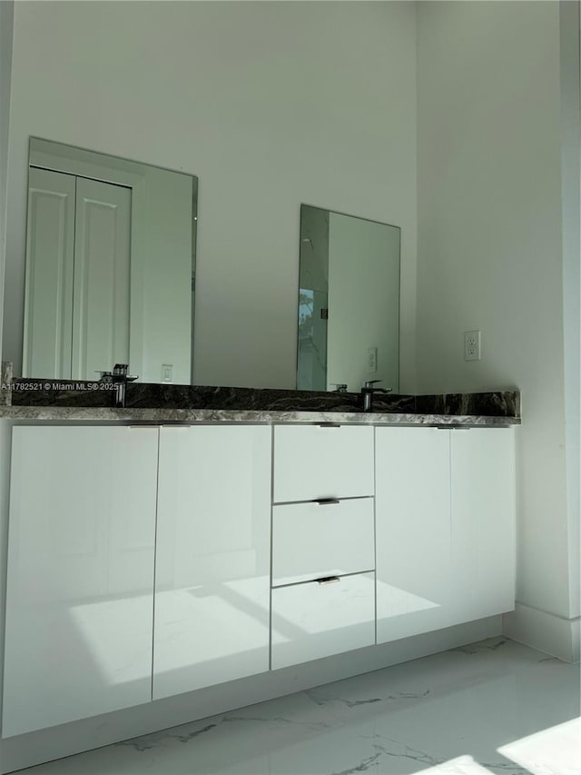 1316 Broadway Ave, Lehigh Acres, FL 33972 - bathroom featuring marble look tiles and double vanity