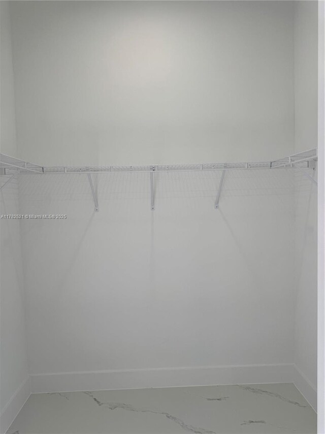 1316 Broadway Ave, Lehigh Acres, FL 33972 - walk in closet with light marble finish flooring
