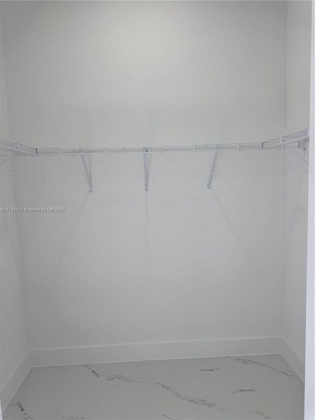1316 Broadway Ave, Lehigh Acres, FL 33972 - walk in closet featuring marble finish flooring