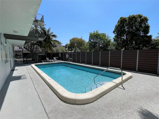 609 NE 13th Ave Unit 301, Fort Lauderdale, FL 33304 - community pool featuring a patio, fence, and stairs