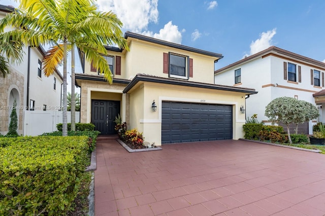 10572 W 35th Way, Hialeah, FL 33018 - view of front of house with stucco siding, an attached garage, and decorative driveway