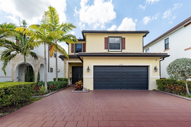 10572 W 35th Way, Hialeah, FL 33018 - view of front facade featuring decorative driveway, a garage, and stucco siding